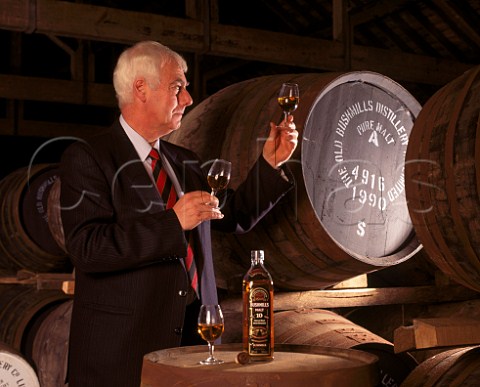 Frank McHardy Master Distiller with samples of whiskey taken from cask  a glass of 10year old malt from bottle is used to ensure consistency of the final blend  Old Bushmills Distillery Bushmills Co Antrim Northern Ireland