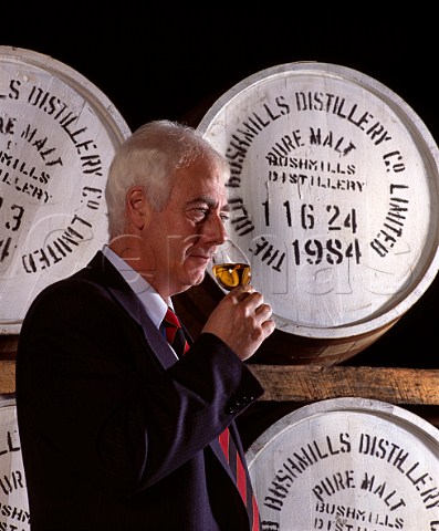 Frank McHardy Master Distiller checks on progress   of his whiskey maturing in cask  Old Bushmills   Distillery Bushmills Co Antrim Northern Ireland