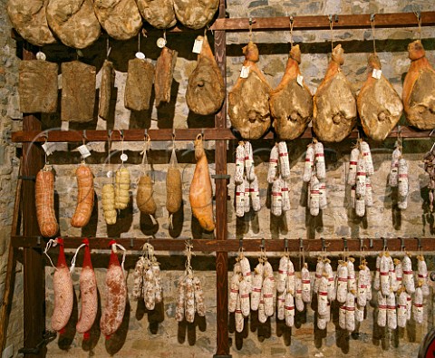 Hams salamis and other cured meats hanging up in  Macelleria Stiaccini Castellina in Chianti Tuscany  Italy