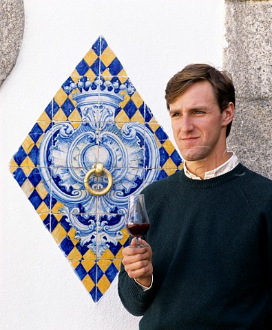 Pedro de Vasconcellos winemaker of Conde de Santar by an azulejos tile decoration in the courtyard of his winery The crown is for Conde count and blue and gold are the colours of Santar Near Viseu Portugal   Dao