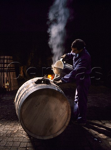 Pouring boiling water into a barrel to clean it after assembly in the cooperage of Ferreira The barrels are made of Portuguese oak   Vila Nova de Gaia Portugal    Douro  Port