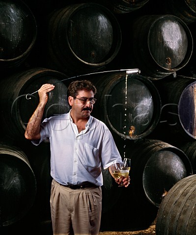 Using a venencia to fill glasses with fino sherry from cask in the bodega of Emilio Lustau Jerez de la Frontera Andalucia Spain  Sherry