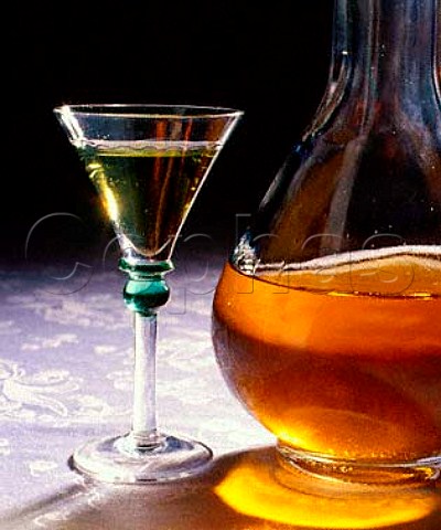 Bottle of Curaao liqueur and glass of Chartreuse