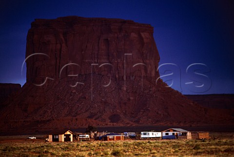 Navajo Indian dwellings in shadow of   Mitchell Butte Monument Valley   Arizona USA
