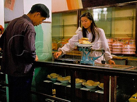 Using an abacus at a department store counter  Kashgar Xinjiang Province China