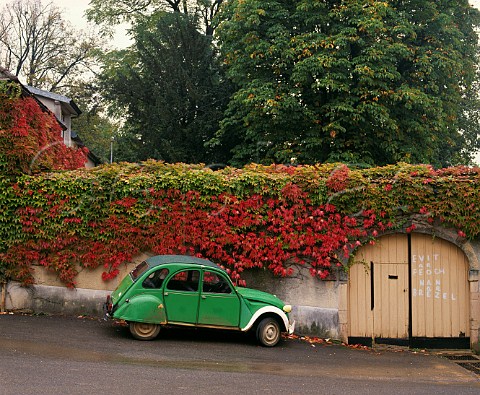 Citroen 2CV car by ivycovered wall in the wine village of AloxeCorton Cte dOr France Cte de Beaune  