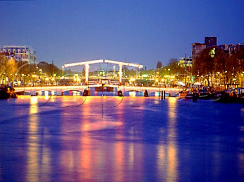Magere Skinny Bridge crossing the river Amstel   in Amsterdam at dusk Netherlands