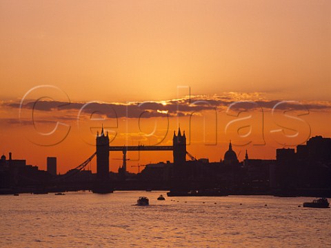 Sunset behind Tower Bridge StPauls Cathedral and   the River Thames  London England