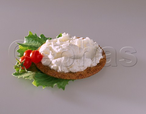 Cream cheese on biscuit with baby tomatoes  Not available for UK food packaging until 2012