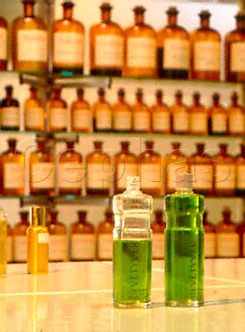 Fragrances bottled in  background are combined to   form the marketed perfumes in the foreground  Parfumerie Fragonard near Grasse   Alpes Maritimes France   Provence