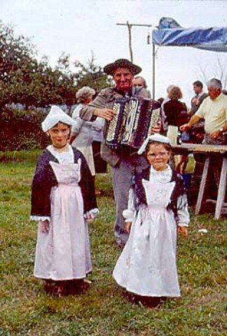 Two girls  5  8 years in traditional  Breton costume with male accordionist  Brittany France
