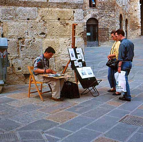 Artist in street of San Gimignano Tuscany   Italy