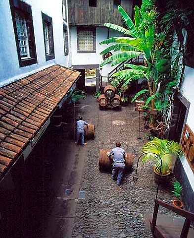 Rolling barrels through courtyard at   Adegas de So Francisco owned by the   Madeira Wine Company  Funchal Madeira  Portugal