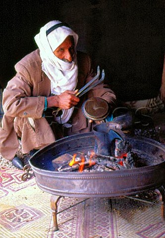 Bedouin preparing arabic coffee in traditional style Israel
