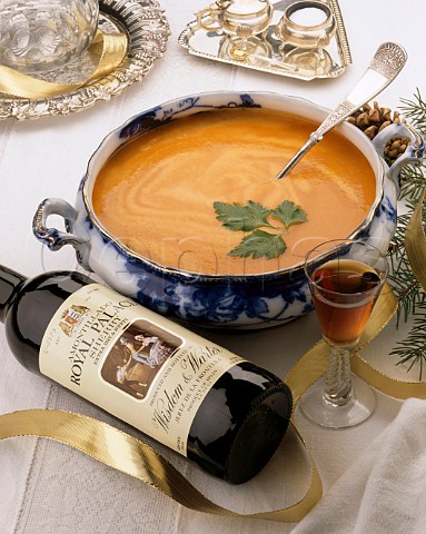 Tureen of carrot soup with a bottle and a glass of   Amontillado Sherry