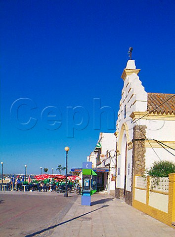 Restaurant and church on the waterfront in Sanlcar   de Barrameda Andaluca Spain