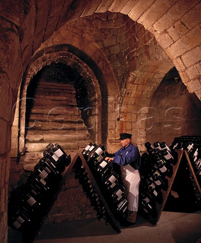 JeanPierre Girondin Chef de Caves working on Jeroboams in pupitres in the remains of the 13thcentury chapel of Saint Niaise Abbey   which form part of the cellars of   Champagne Taittinger Reims Marne France
