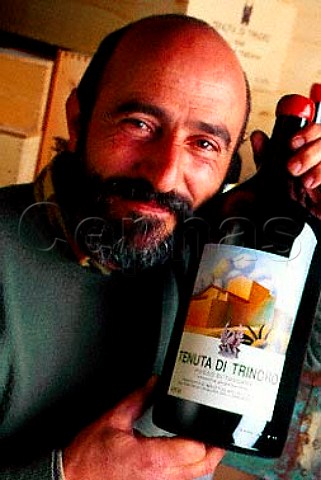 Stefano Piccio oenologist with   bottle of his Rosso di Toscana   Tenuta di Trinoro Sarteano Tuscany   Italy   Colli Senesi