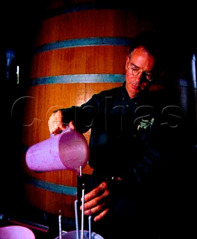 Jerry Egan manager of Robert Mondavis   Carneros Winery checking the specific gravity of   fermenting Cabernet Sauvignon  Napa California