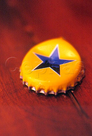 Crown cap from a bottle of Newcastle   Brown Ale displaying their famous star   emblem