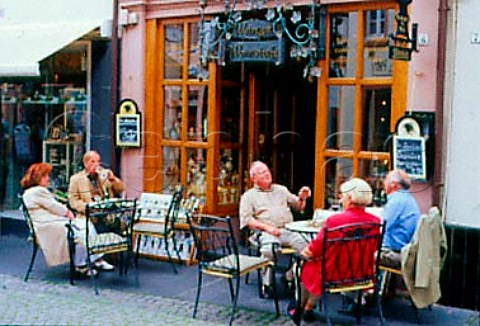 People drinking wine outside a   weinstube Bernkastel Germany    Mosel