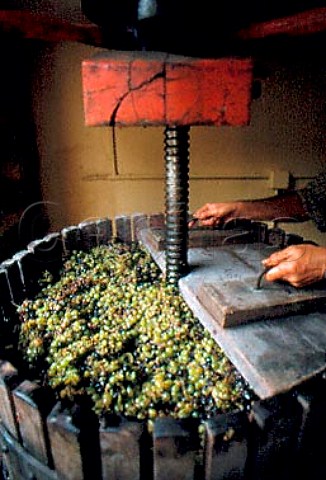 Putting header boards on a small grape   press filled with Aligot grapes  Fixin Cte dOr France