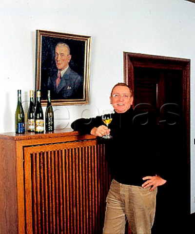 Raimund Prm winemakerowner of Weingut SAPrm   next to a portrait of the winerys founder Sebastian   Alois Prm Wehlen Germany    Mosel