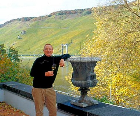 Raimund Prm winemakerowner of Weingut SAPrm   with the Mosel river and Wehlener Sonnenuhr vineyard   behind Wehlen Germany    Mosel