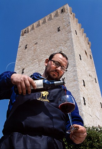 Massimo Busi cellarman pouring glass   of wine outside the winery of   Rocca di Fabbri  Fabbri near Montefalco Umbria Italy