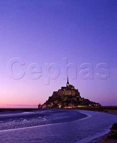 le MontStMichel at dusk built on the island of   Mont Tombe the 10th century Benedictine abbey is now   a national monument Manche France   Basse Normandie