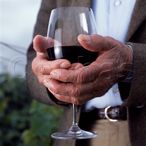 Hands of Robert Mondavi holding glass of Cabernet  Sauvignon    Oakville Napa Valley California