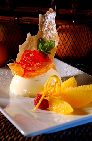 Dessert Orange mousse with raspberry orange segments and craquelline