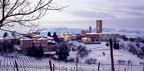 Heavy snowfall on the village and vineyards of Barbaresco with winery of Angelo Gaja on left Piemonte Italy