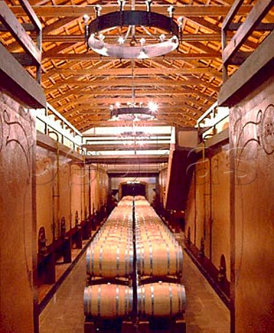 Barrels flanked by concrete tanks in the   Marchese di Villamarina cellar of Sella  Mosca    built in 1903    Alghero Sardinia Italy