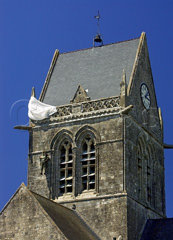 Dummy paratrooper in honour of John Stee on the   church tower of  SteMreEglise Manche France    BasseNormandie
