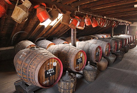 Barrels of Madeira wine maturing by the natural   Canteiro process in a loft of the Old Blandy Wine   Lodge Arcadas de So Francisco part of the Madeira   Wine Company Funchal Madeira Portugal