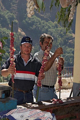 Preparing giant skewers of steak for barbequeing   during a festival at Curral das Freiras  Madeira   Portugal
