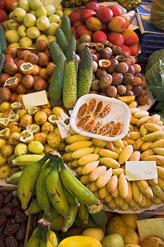 Display of Passion Fruits banana pineapple   papaya on a market stall at the Mercado dos   Lavradores Funchal Madeira Portugal