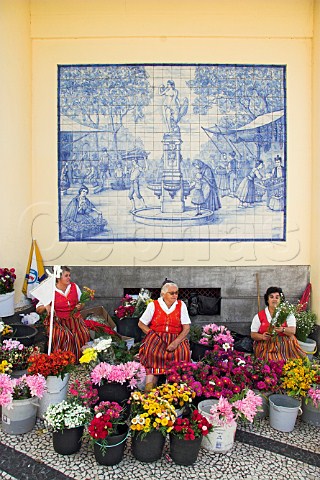 Flower sellers in traditional dress outside the   Mercado dos Lavradores Funchal Madeira Portugal