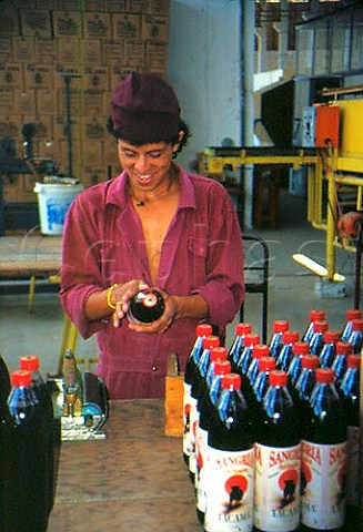 Labelling bottles of Sangria at the   Tacama winery in the Ica Valley Peru