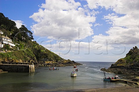Small boats at the entrance to Polperro harbour   Cornwall England
