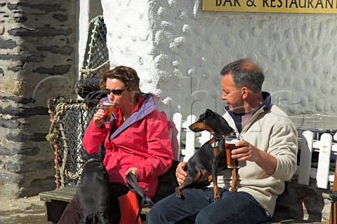 Drinking beer outside the Golden Lion pub Port   Isaac Cornwall England