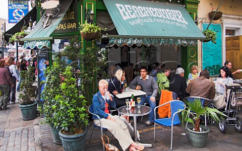 People drinking wine outside the Beachcomber seafood  restaurant Greenwich London England