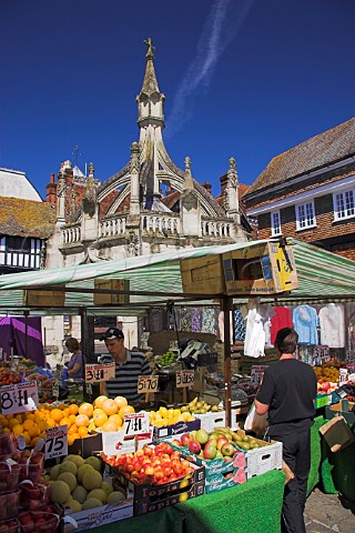 Vegetable stall in Butcher Row in front of the 15th   Century Poultry Cross Salisbury Wiltshire England