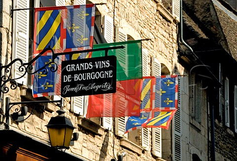 Flags and Grands Vins de Bourgogne sign outside   the prestigious wine shop of JeanLuc Aegerter Rue   Carnot Beaune Cte dOr France