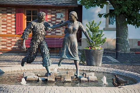 Small fountain and bronze statue in the wine village   of Forst Pfalz Germany