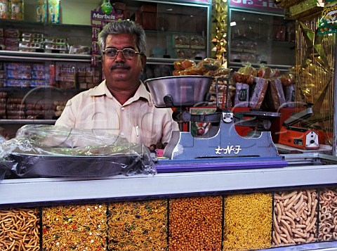 Indian man behind the counter in Anjali Sweet shop   Palavakkam Chennai Madras India