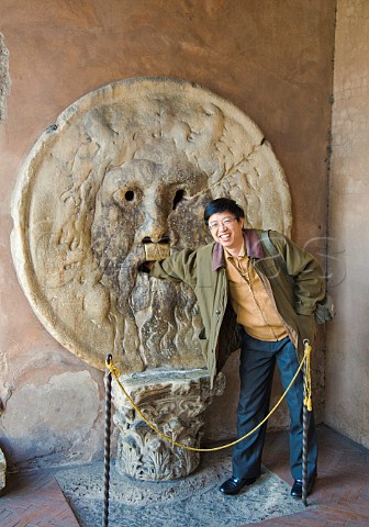 Chinese tourist at the Bocca della Verit at Santa Maria in Cosmedin Rome Italy