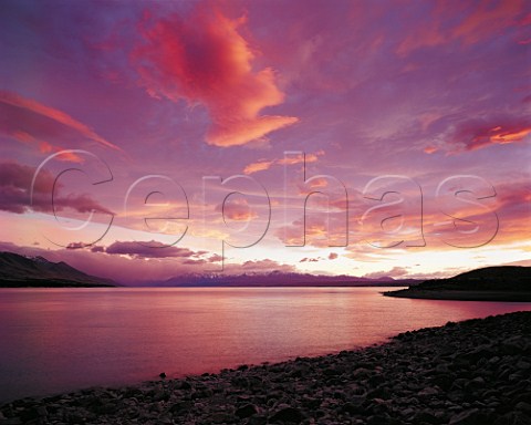 Dramatic pink sunrise over Lake Pukaki South Island New Zealand