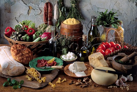 Rustic display of Italian cheeses and vegetables
